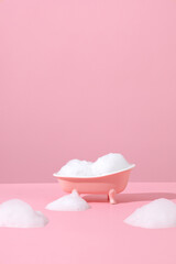 Pink miniature bathtub in pink bathroom with bubble