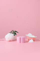 Pink miniature bathtub in pink bathroom with bubble product stand for packshot