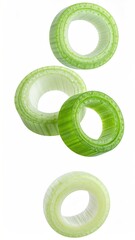 Four green onion slices float on white