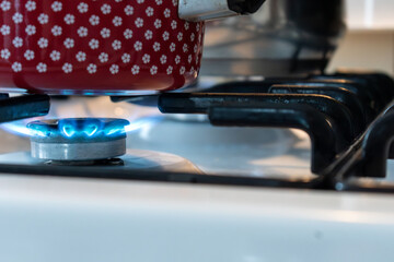 Saucepan on gas stove, gas cooker in the kitchen