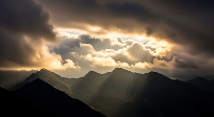 Dramatic Mountainscape - Sunbeams Pierce Storm Clouds Over Jagged Peaks.