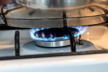 Saucepan on gas stove, gas cooker in the kitchen