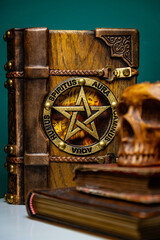 old wooden-leather book with a pentagram 