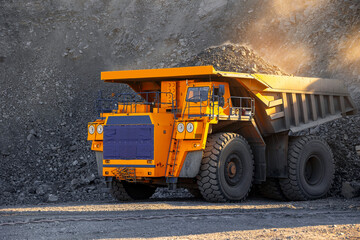 Large dump truck in open coal mine working during winter operations