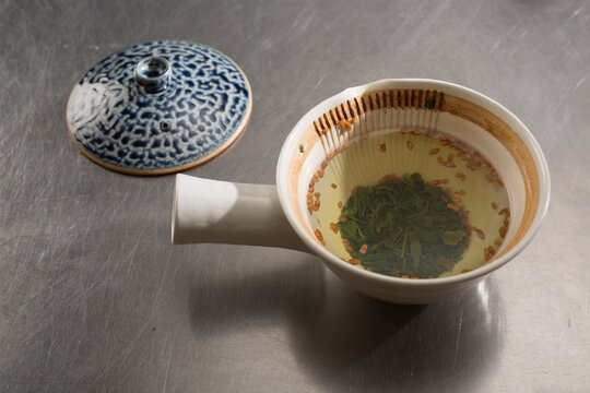 Genmaicha Tea Steeping in Traditional Japanese Kyusu Teapot with Patterned Lid