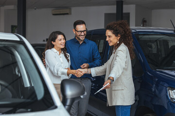 Friends And Colleagues Celebrate A Car Deal After Handshake In A Modern Showroom © Dragana Gordic