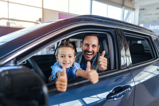 Happy Father And Son In Car Showroom, Giving Thumbs Up, Family Bond, Joyful Drive Today