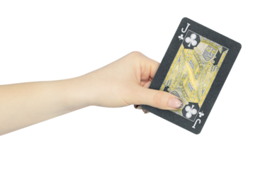 playing card clubs jack in hand, outstretched hand with black playing card isolated from background