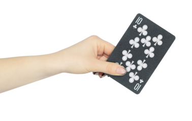 playing card clubs 10 in hand, outstretched hand with black playing card isolated from background