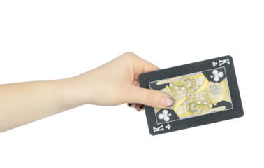 playing card clubs king in hand, outstretched hand with black playing card isolated from background