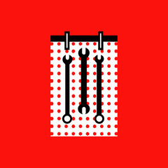 Tools on a pegboard with red dots