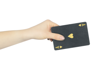 playing card hearts ace in hand, outstretched hand with black playing card isolated from background