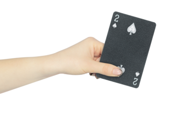 playing card spades 2 in hand, outstretched hand with black playing card isolated from background