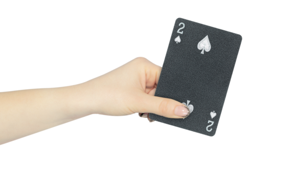 playing card spades 2 in hand, outstretched hand with black playing card isolated from background