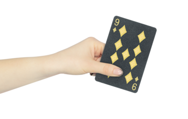 playing card diamonds 9 in hand, outstretched hand with black playing card isolated from background
