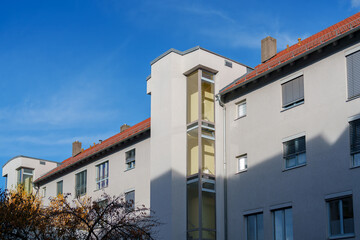 Modern apartment building with unique architecture in a clear blue sky during daytime