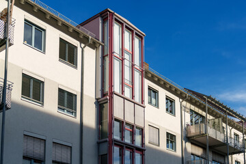 Modern architectural design in urban building with contrasting colors under clear blue sky