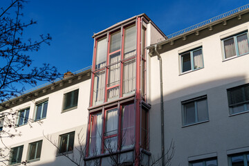 Unique architectural design of a modern building in an urban setting under clear blue sky