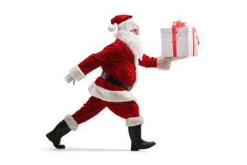 Santa claus in a rush carrying a present and walking fast