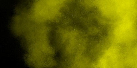 Yellow color powder explosion cloud isolated on black background.  dust smoke . Yellow dust particles explosion background .
