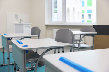 Stylish classroom with desks and chairs at school, closeup