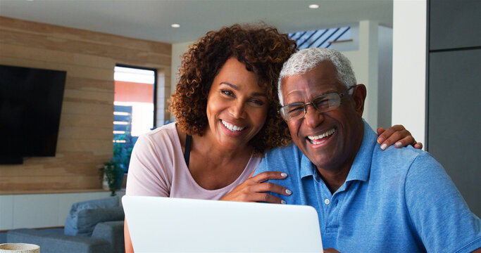 Portrait Of Senior African American Couple Using Laptop At Home