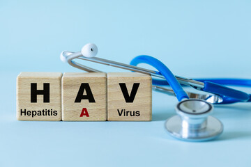 Foodborne hepatitis A. Hepatitis virus. Infectious disease, disease of dirty hands, health concept. Written on wooden blocks. Stethoscope.