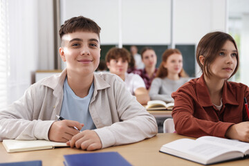 Teacher and students during lesson in classroom, selective focus