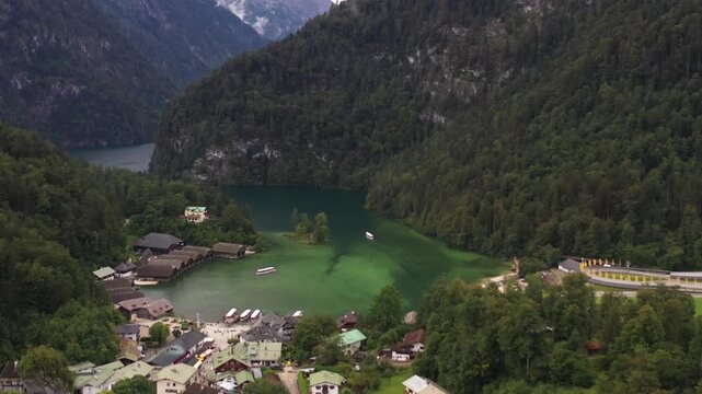 Aerial view of Koenigssee's emerald waters, framed by verdant mountains and charming boathouses, a scene of serene beauty and timeless allure, Schoenau am Koenigssee, Bavaria, Germany.