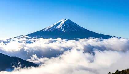 Snowy mountain peak majestically rising above a sea of fluffy clouds under a clear blue sky