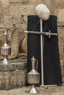 National Dagestani men's clothing, old jugs and a dagger near the walls of an ancient fortress