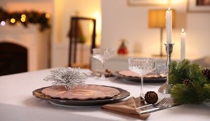 Festive table setting with Christmas decor and burning candles indoors, closeup