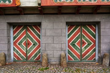 Old house facade with two wooden doors.