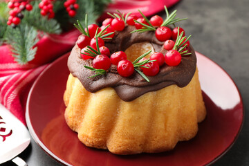 Tasty cake with cranberries and Christmas decor on grey table, closeup