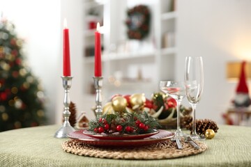 Festive table setting with Christmas decor and burning candles indoors, closeup
