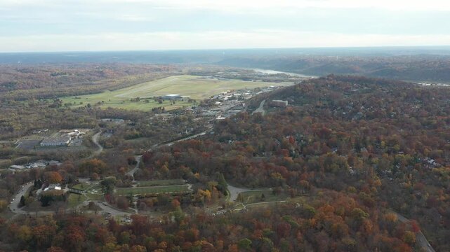 Aerial view of Ault Park Avenue winding through a forest, with houses visible on the right, showcasing the autumnal colors, Cincinnati, Ohio, United States.