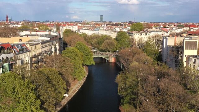 Aerial view of the Spree river winding through Berlin, with a bridge connecting tree-lined banks, creating a tranquil scene in the cityscape, Berlin, Berlin, Germany.