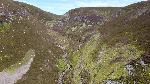 Aerial view of the rugged terrain of Glen Esk with its steep slopes and lush greenery creating a textured landscape, Brechin, Scotland, United Kingdom.