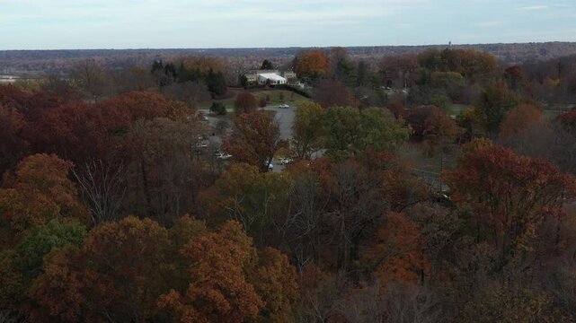 Aerial view of Ault Park Pavilion surrounded by lush trees displaying autumn colors, offering a serene landscape, Cincinnati, Ohio, United States.