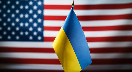 American flag lying on wet pavement showing red and white stripes and stars on blue background