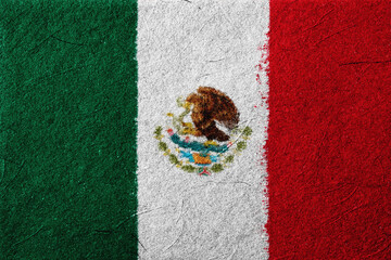 The textured surface displays the colors and emblem associated with the Mexican flag, symbolizing...