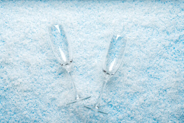 New Year and Christmas themes, holiday, Minimalist top view of two empty champagne flutes lying on...