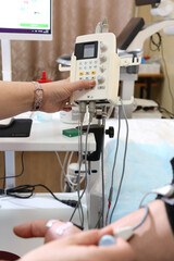 Electromyography. A man undergoes an examination on an electromyograph. A new field in medicine is electroneuromyography. 