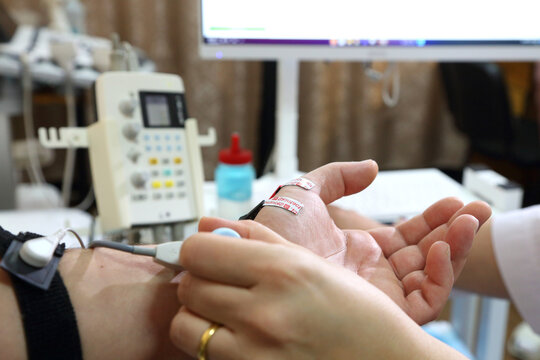 Electromyography. A man undergoes an examination on an electromyograph. A new field in medicine is electroneuromyography. 