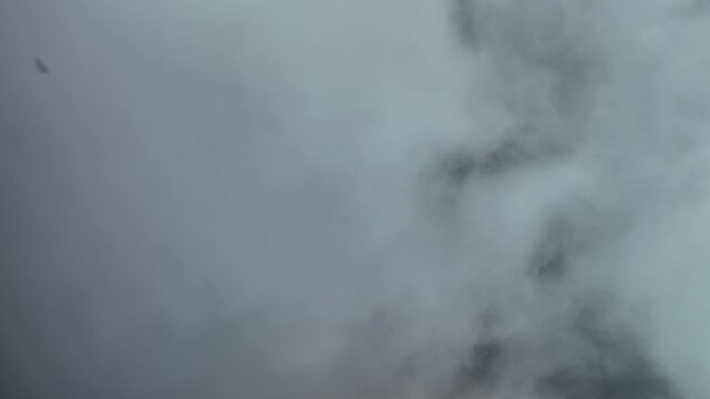Aerial view of dense, swirling clouds creating an ethereal scene along the Route des Cretes, Fellering, Grand Est, France.
