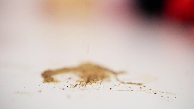 black pepper on bright surface, pile of pepper grains on white tabletop, closeup of pepper granules with soft background, detailed shot of aromatic black pepper scattered across smooth white surface