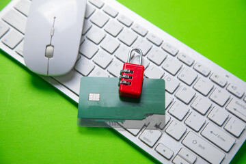 Padlock and credit card on the green background.
