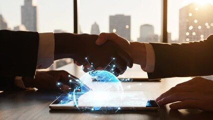Business handshake with digital globe and network connections on tablet in modern office setting - Powered by Adobe