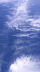 Wispy Clouds in a Deep Blue Sky An Ethereal Sky View for Backgrounds and Textures