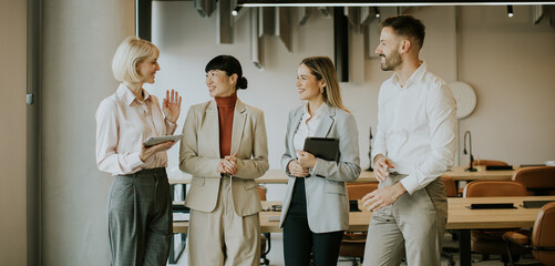 Business team discusses ideas in modern office space during daylight hours
